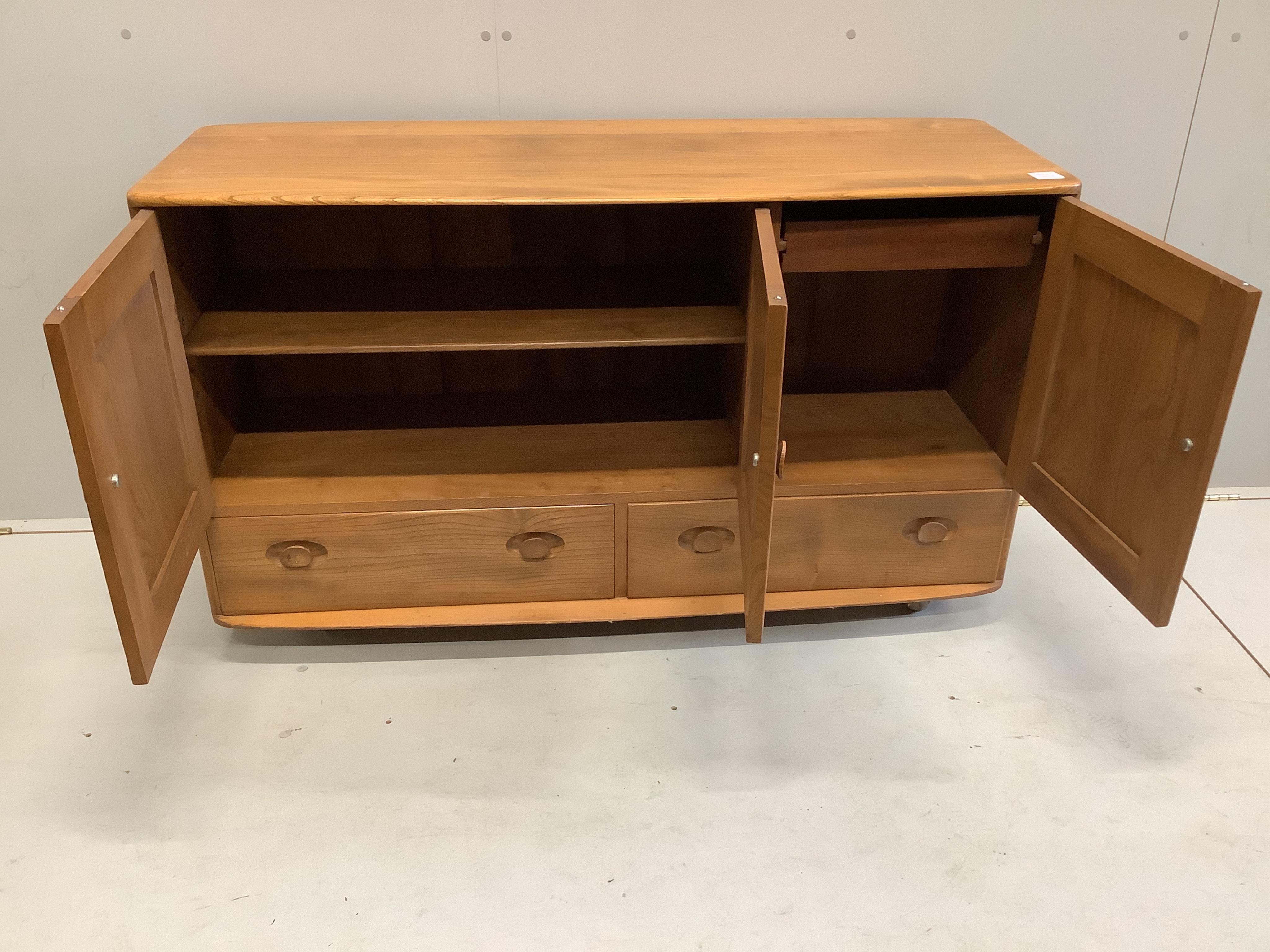 An Ercol Windsor elm sideboard, width 130cm, depth 47cm, height 76cm